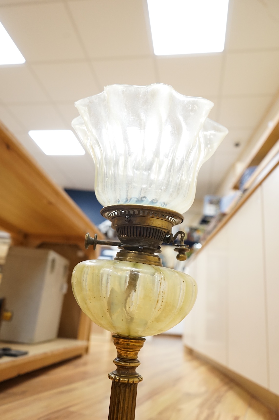 An Edwardian vaseline glass and brass oil lamp and shade, 56cm high